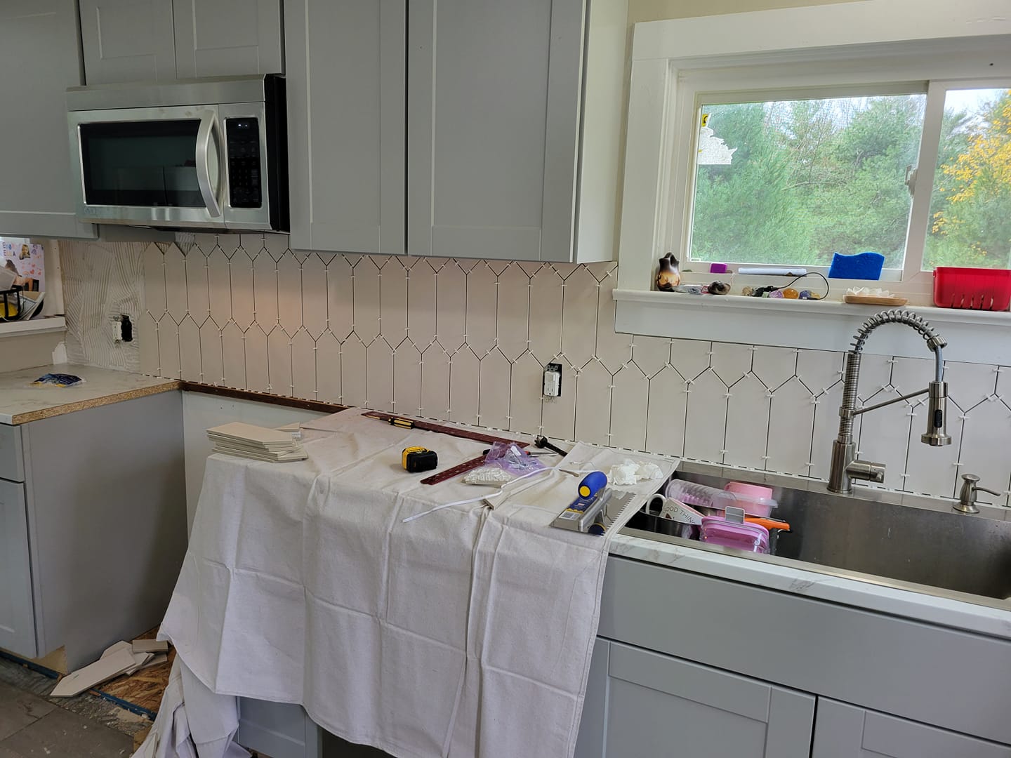 Modular home installation with crane setting modules on foundation