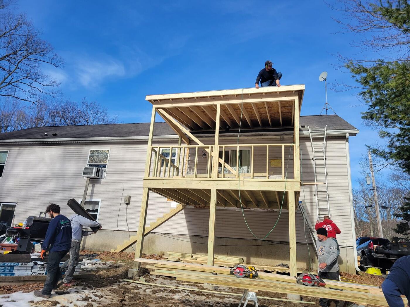 Custom wooden deck with pergola and privacy fencing