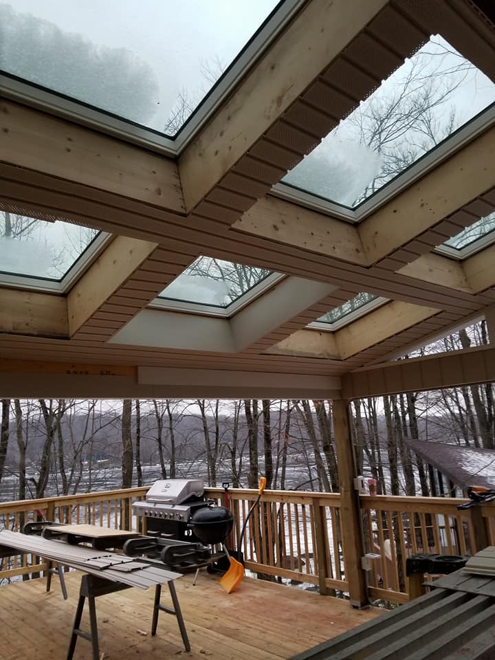 Covered deck with skylight windows and mountain views