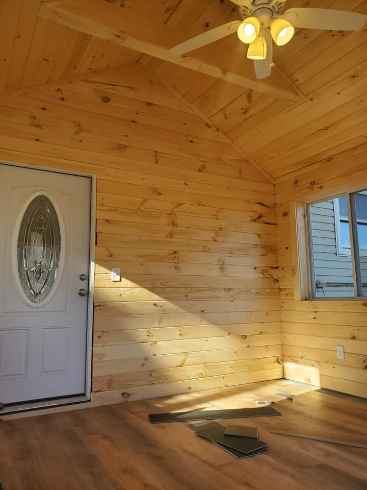 Pine-paneled sunroom with vaulted ceiling